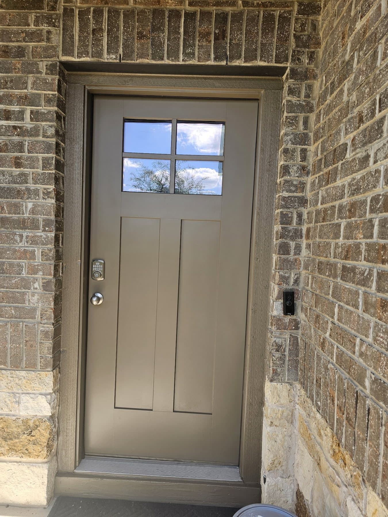 Painted front door set into brick and stone entry