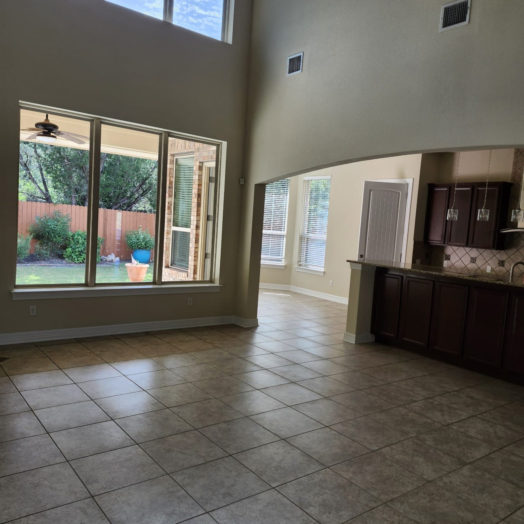 Open plan living and kitchen area with large format tile flooring