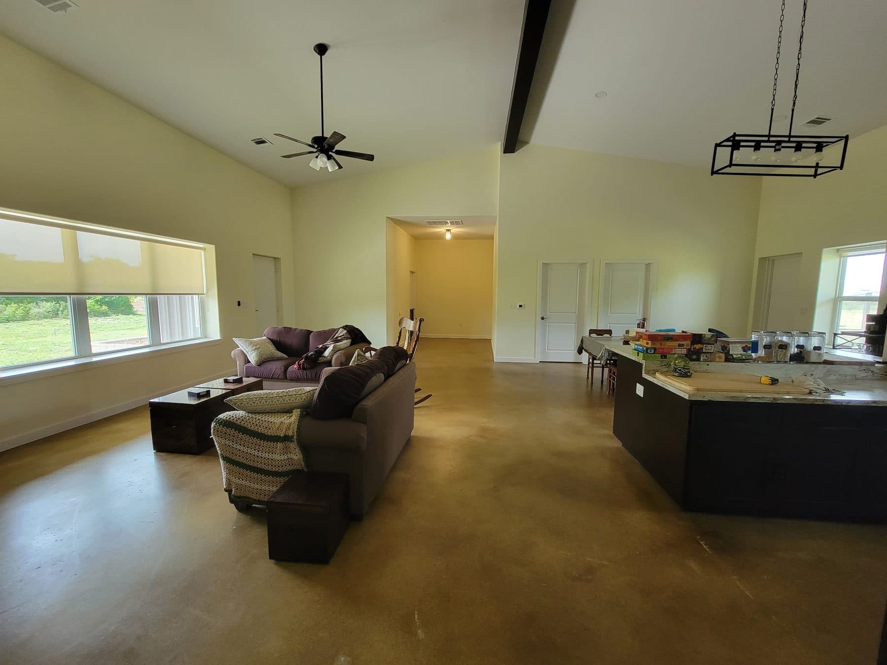 Freshly painted open plan living and kitchen with exposed beam